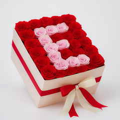Luxury box of red and pink roses arranged in heart shape for flower delivery