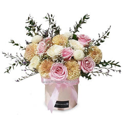 Romantic bloom box with pink roses and chrysanthemums, perfect for flower delivery