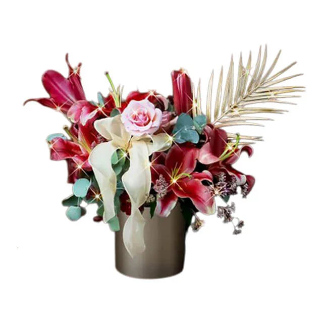 Elegant Deepavali floral arrangement with red lilies, pink rose, gold palm in vase for flower delivery