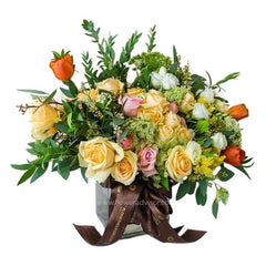 Mixed bouquet of yellow roses, tulips, alstroemeria in a vase for flower delivery