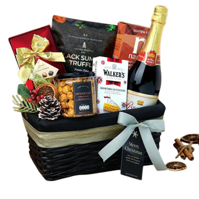 Festive flower delivery hamper with chocolates, wine, cookies, and a pinecone decoration