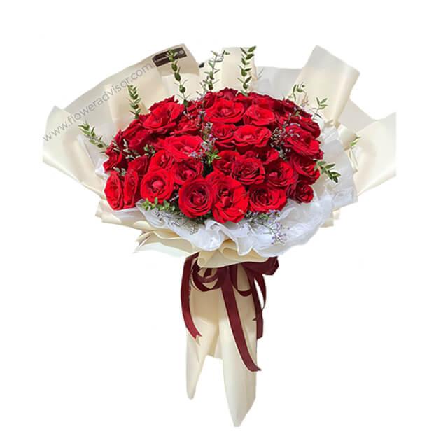 Elegant bouquet of 44 red roses with greenery, perfect for flower delivery in Singapore
