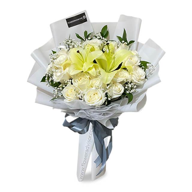 Elegant white flower bouquet with lilies and roses, perfect for flower delivery in Singapore