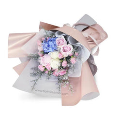 Elegant flower delivery bouquet with blue hydrangeas, pink roses, white roses, and pastel wrap