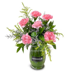 Pink carnation bouquet in a glass vase, ideal for flower delivery in Singapore