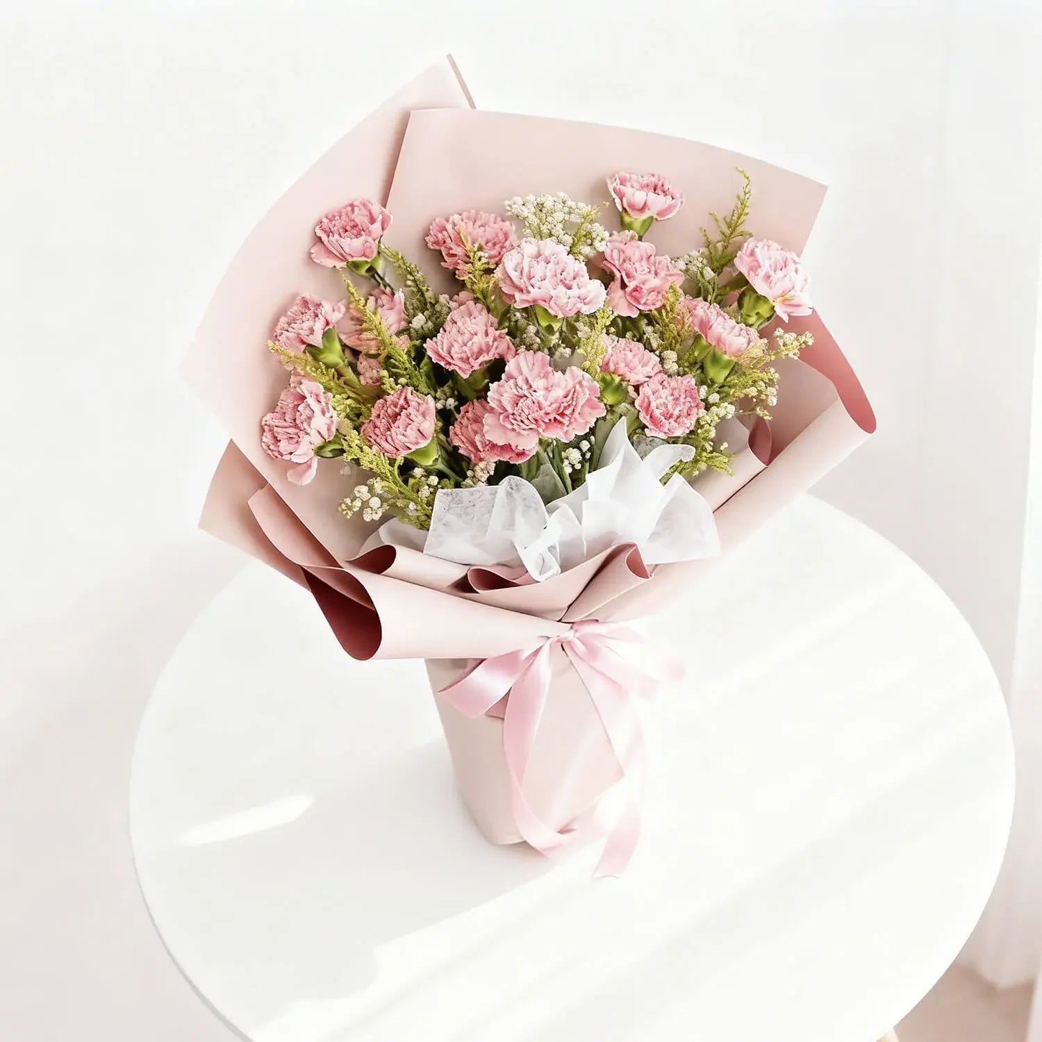 Pink carnation bouquet wrapped in pastel paper for flower delivery in Singapore