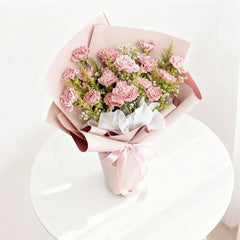 Pink carnation bouquet wrapped in pastel paper for flower delivery in Singapore