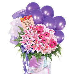 Grand opening flower stand with purple balloons, pink lilies and gerberas for flower delivery