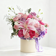 Elegant flower bouquet in a hatbox with lilies, roses, perfect for flower delivery Singapore