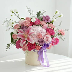 Elegant flower bouquet with pink lilies, roses, carnations and bow for flower delivery