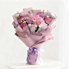 Elegant pink and purple flower bouquet in pastel wrap for flower delivery