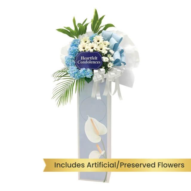Condolence flower stand with blue and white flowers for delivery in Singapore