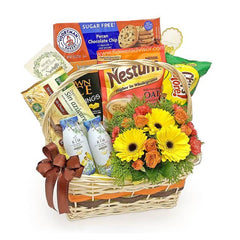 Flower delivery basket with yellow and orange flowers, gourmet snacks, and a brown ribbon.
