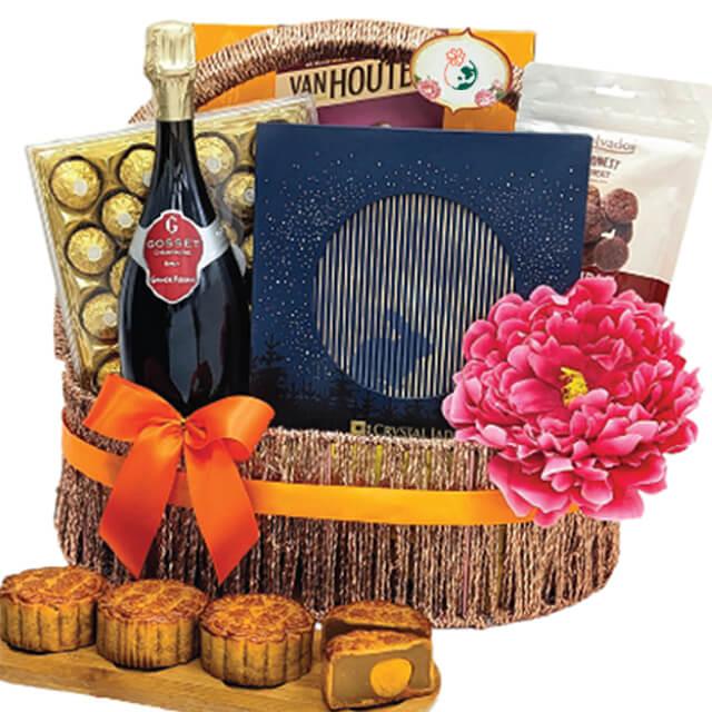 Elegant flower gift basket with mooncakes, chocolates, wine, and a large pink blossom