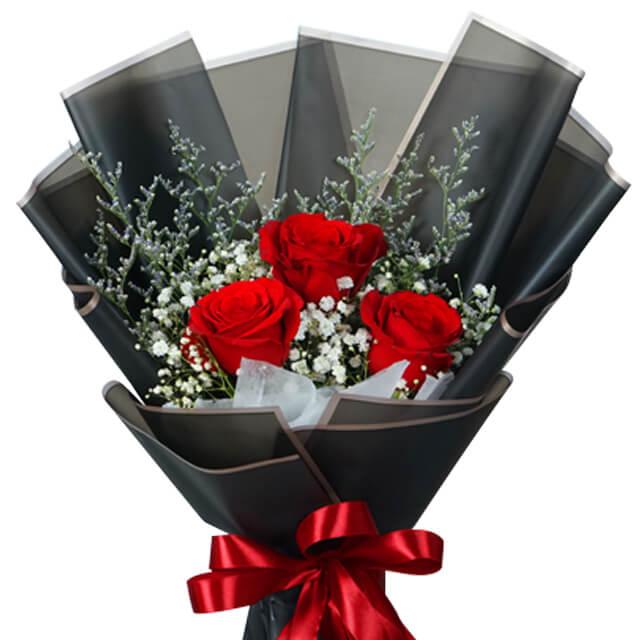 Red rose bouquet with greenery and baby's breath in black wrapping, ideal for flower delivery