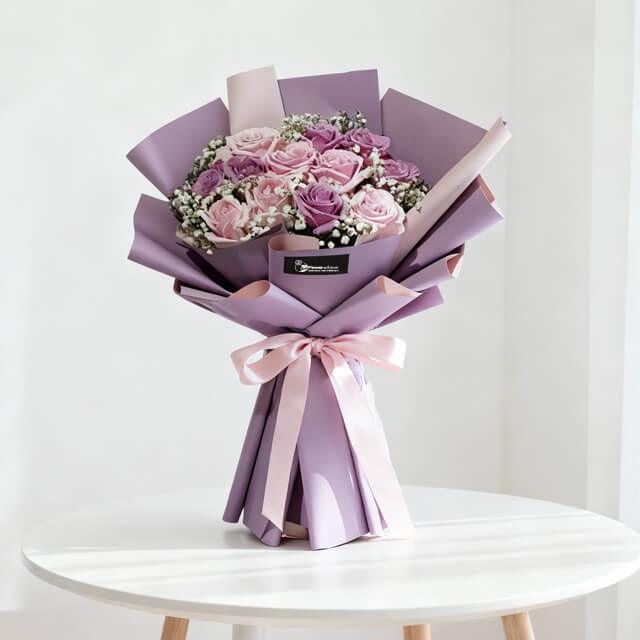 Elegant purple and pink rose bouquet with baby’s breath, ideal for flower delivery in Singapore