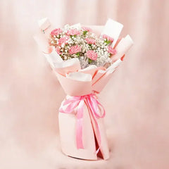 Pink carnation bouquet with baby’s breath, gift-wrapped for flower delivery in Singapore