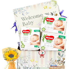 Baby gift hamper with Huggies diapers, welcome baby sign, and fresh sunflower bouquet for flower delivery
