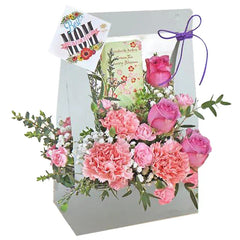Flower delivery of a pink bloom box with roses, carnations, and a best mom card