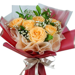 Peach rose bouquet with baby's breath for flower delivery, wrapped in red ribbon