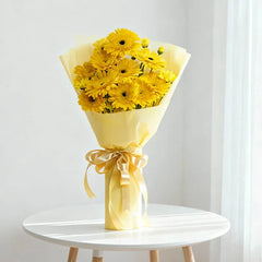 Yellow gerbera daisy bouquet with ribbon, perfect for flower delivery in Singapore