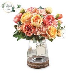 Summer flower bouquet with pink and yellow blooms in vase for flower delivery