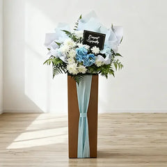 Elegant standing flower arrangement with white and blue blooms for flower delivery