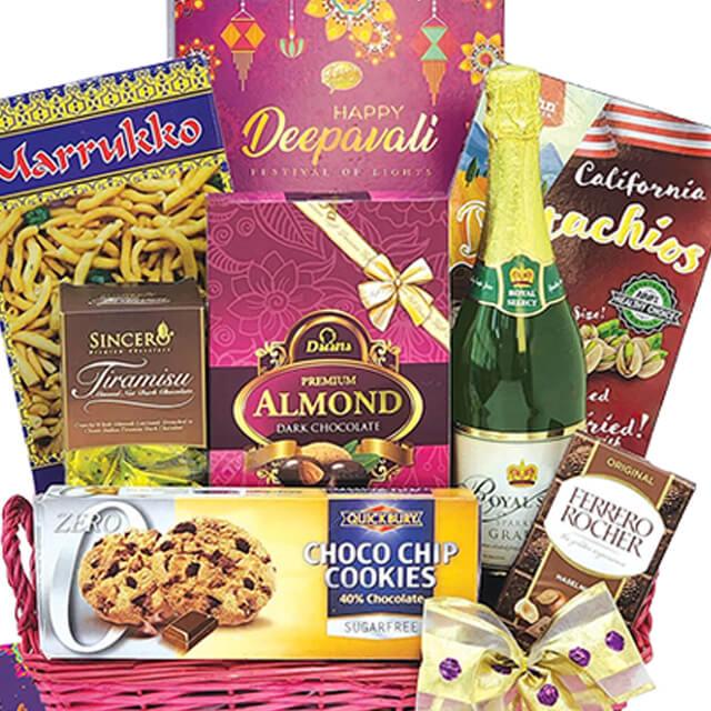 Deepavali gift hamper with assorted snacks, chocolates, cookies and sparkling drink for flower delivery.