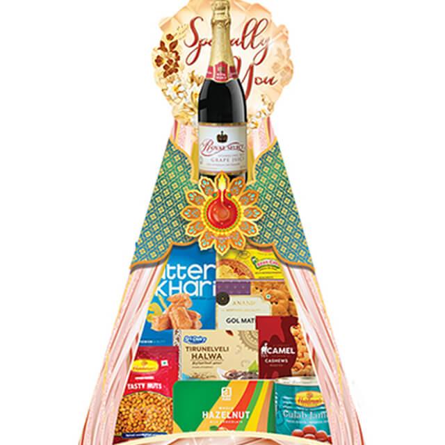 Festive gift hamper with sparkling drink, assorted snacks and treats, ideal for flower delivery.