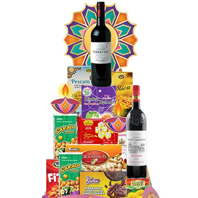Diwali gift hamper with wine, assorted snacks and festive decorations for flower delivery