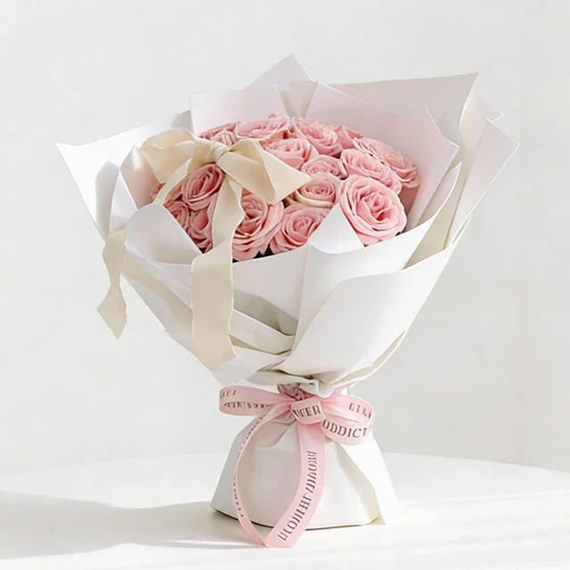 Elegant pink rose bouquet with white wrapping, perfect for flower delivery in Singapore