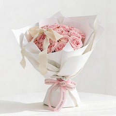 Elegant pink rose bouquet with white wrapping, perfect for flower delivery in Singapore