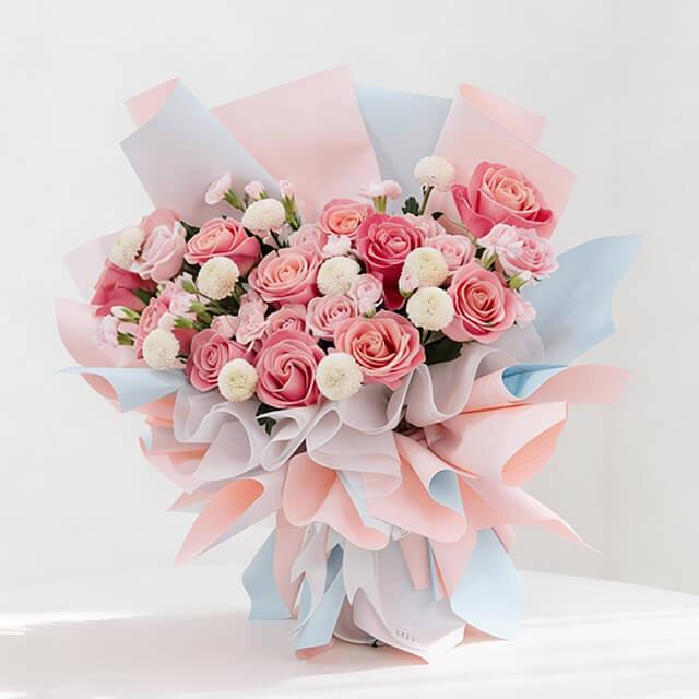 Pink rose and white pompom bouquet with pastel wrapping for flower delivery