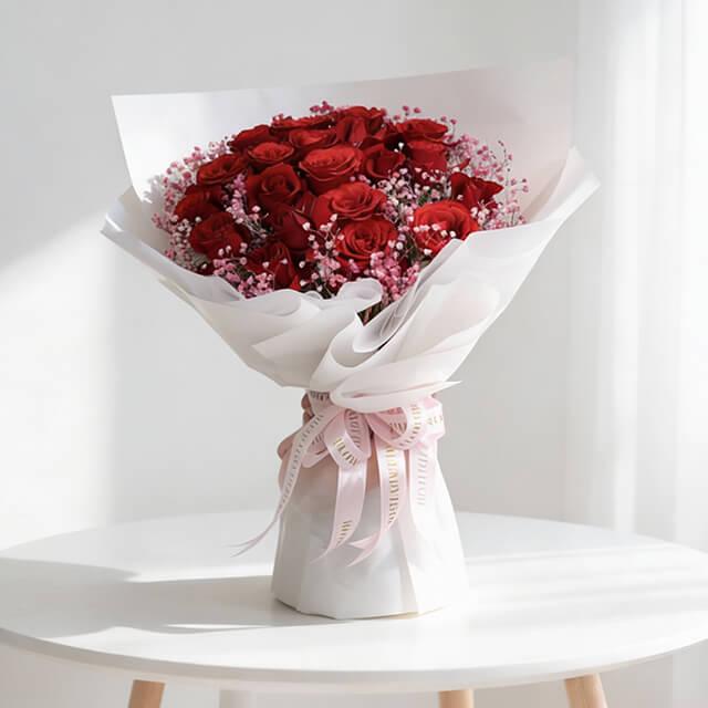 Fresh red rose bouquet with pink filler flowers, wrapped for flower delivery