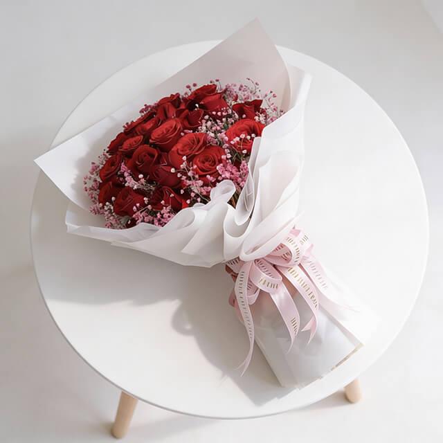 Elegant red rose bouquet with pink fillers and ribbon, ideal for flower delivery in Singapore