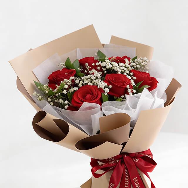 Red rose bouquet with baby's breath in kraft paper, ideal for flower delivery in Singapore