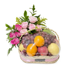 Flower delivery basket with pink roses, oranges, apples, pears, and grapes arrangement