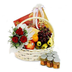Flower delivery basket with red rose bouquet, fresh fruits and health tonic jars