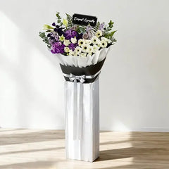 Elegant condolence flower stand with purple and white blooms for flower delivery Singapore