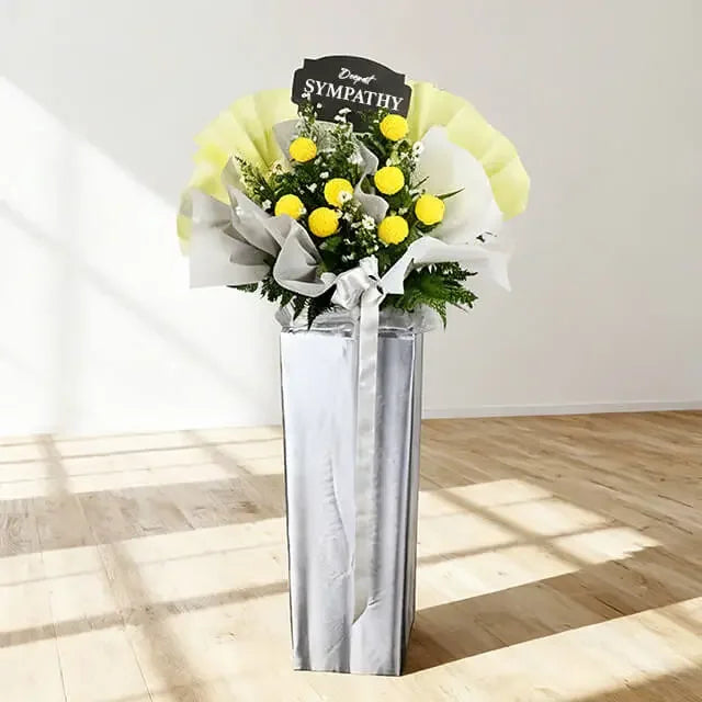 Yellow and white sympathy flower stand with fresh bouquet, suitable for condolence flower delivery