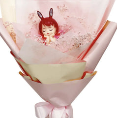 Pink bouquet with preserved flowers and an angel doll for flower delivery