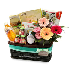 Flower delivery hamper with fresh gerbera flowers and assorted snacks in a gift basket