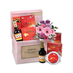 Get well soon hamper with fresh pink flowers and gift items for flower delivery