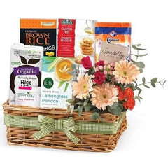 Gift basket with assorted snacks and fresh flowers, perfect for flower delivery in Singapore