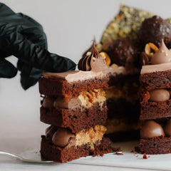 Luxurious chocolate cake slice with creamy layers, perfect for celebration flower delivery