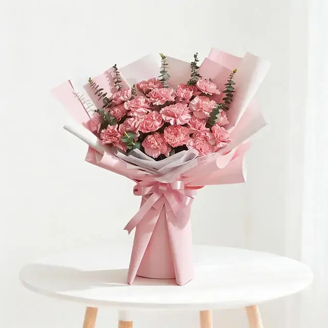 Pink carnation bouquet wrapped in pink paper, perfect for flower delivery across Singapore
