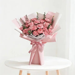 Pink carnation bouquet wrapped in pink paper, perfect for flower delivery across Singapore