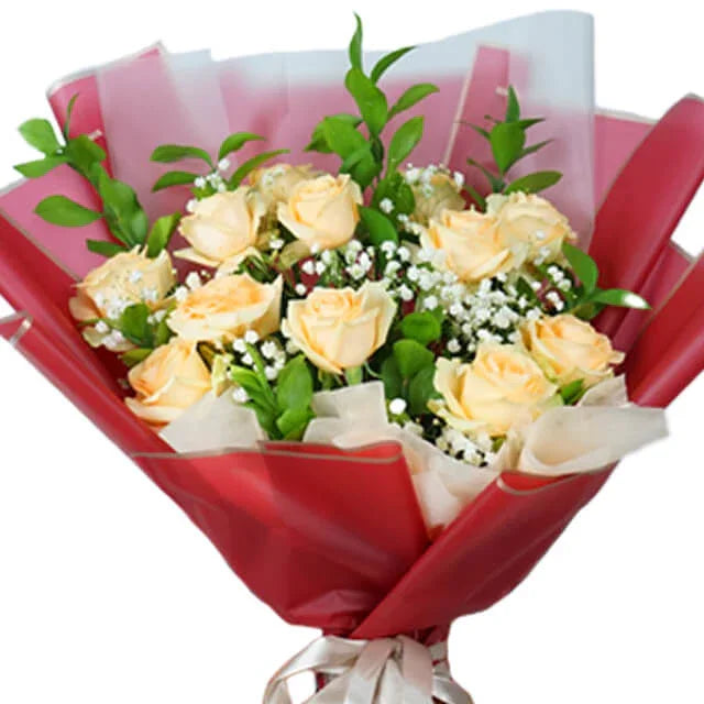Elegant bouquet of pale yellow roses with baby's breath for flower delivery, wrapped in red paper.