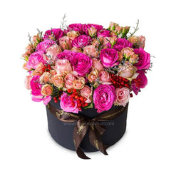 Mixed pink and peach roses in bloom box with fillers, ideal for flower delivery in Singapore
