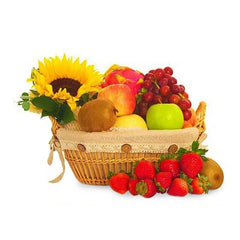 Sunflower fruit basket with fresh strawberries, apples, grapes, and flower delivery arrangement.